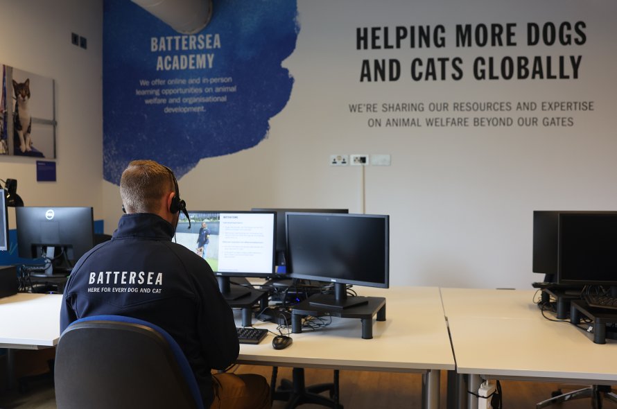 A man seated at a desk focused on training