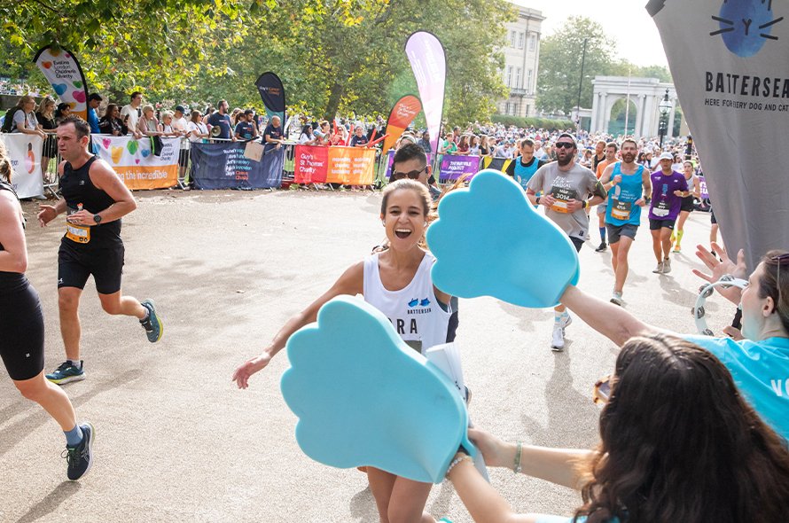 A runner high fiving supporters