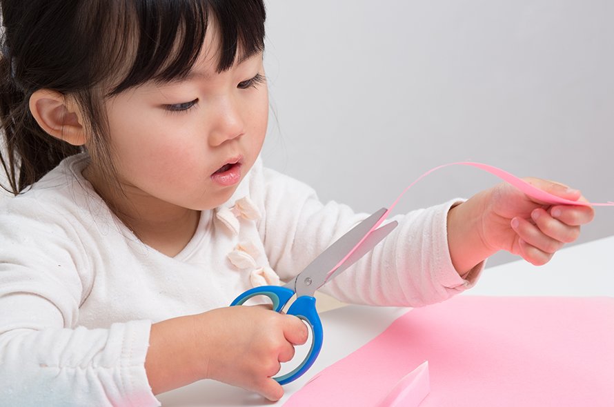 A small child cutting paper