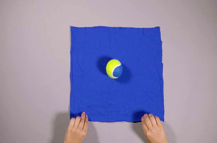 Tennis ball in the middle of the t-shirt fabric