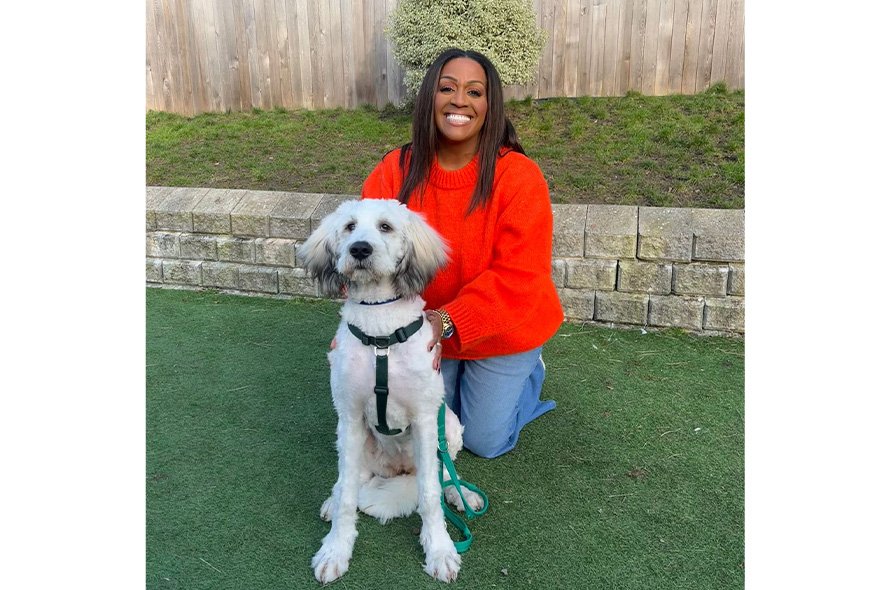 Alison Hammond sitting outside with big white fluffy dog 