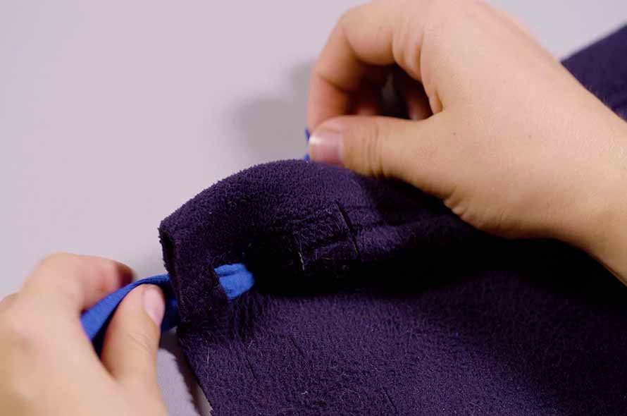 Pieces of a jumper being tied together