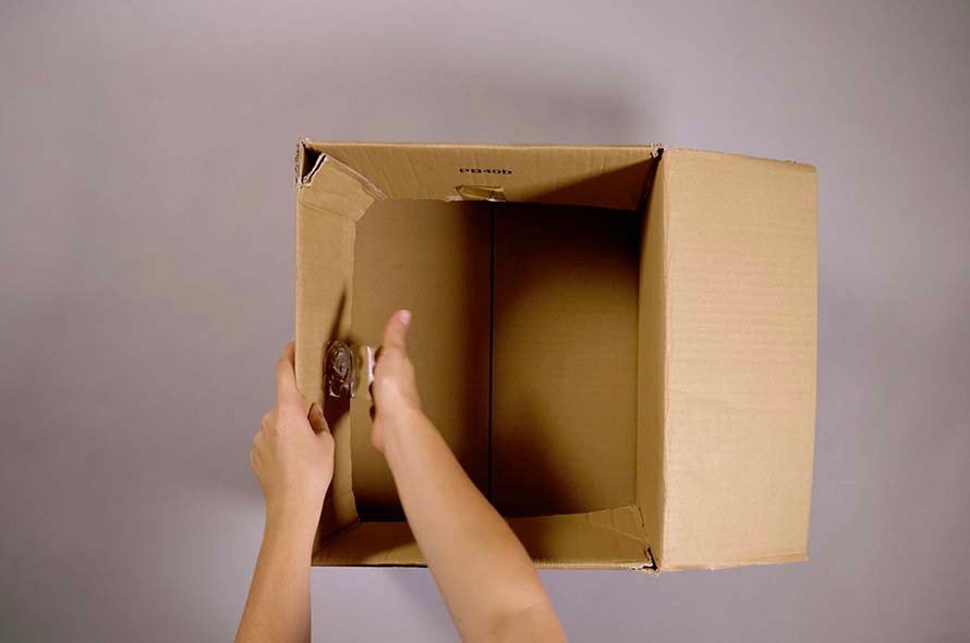 Person opening up a cardboard box