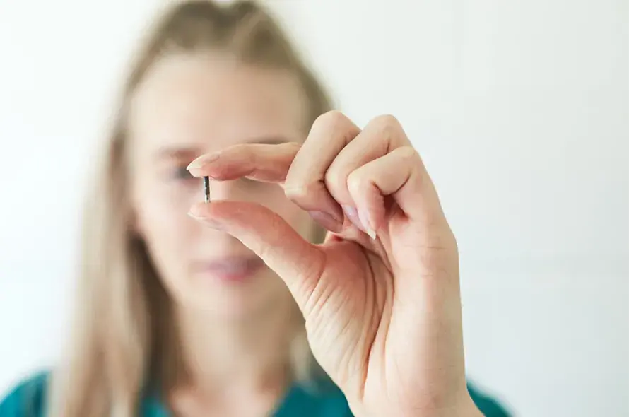 A vet holding a microchip