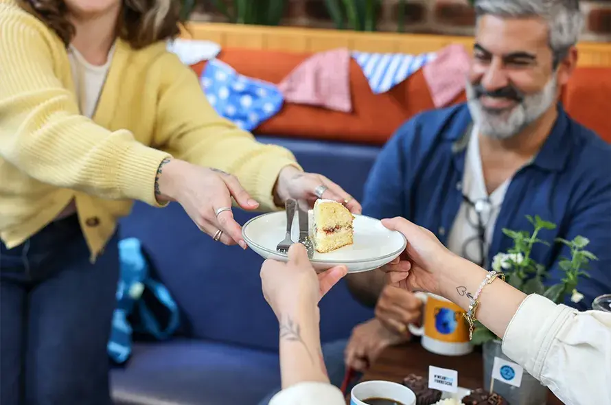 A group of people enjoying cake together