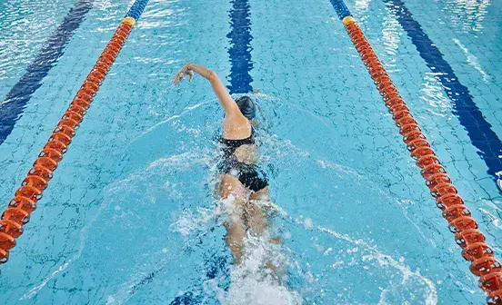 Person swimming in a pool