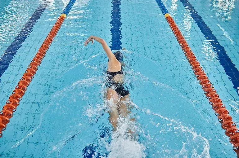 Person swimming in a pool
