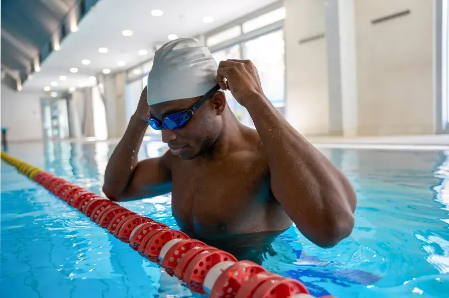 A person adjusting their swimming googles