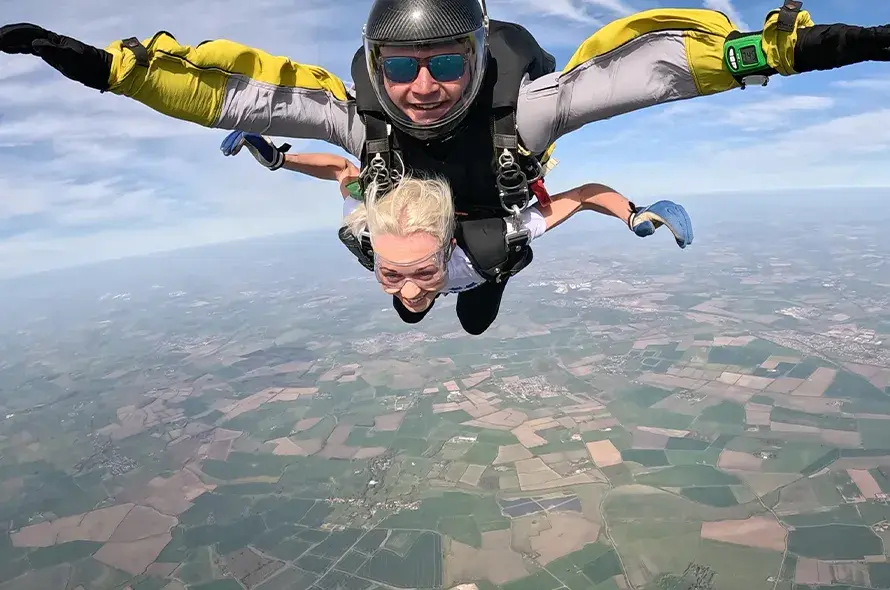 A person skydiving with an instructor